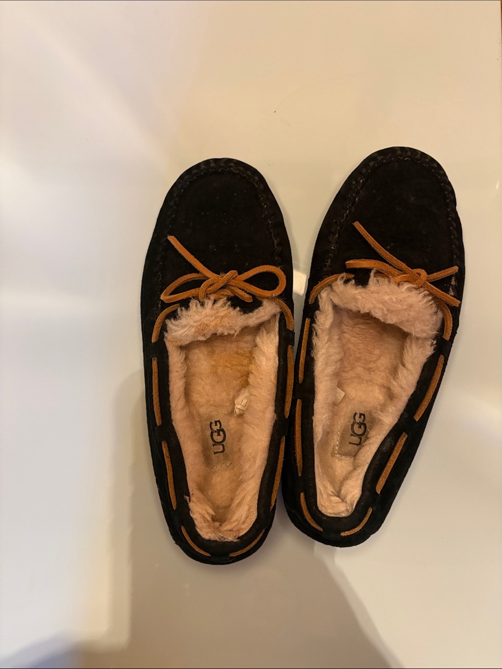 UGG Black Suede Moccasin Slippers with Tan Trim